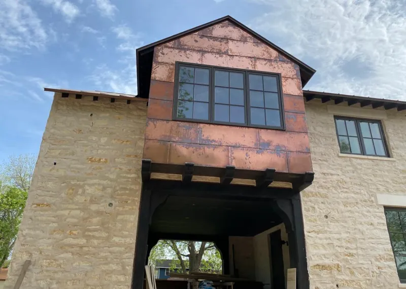 Copper metal panel facade on a stone building for Skylight Installation in Lehman